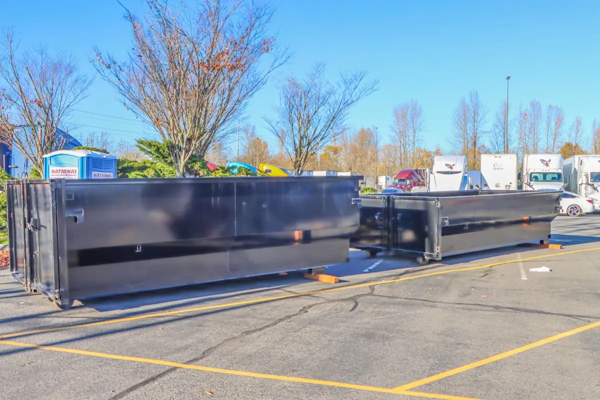 Professional dumpster rental service with roll-off container on residential driveway in Thompson's Station